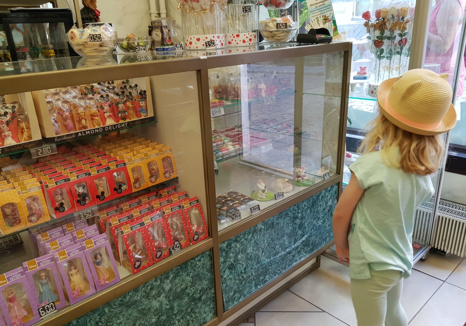 My daughter looks at some of the marzipan shapes in a shop with museum in the Old Town - the marzipan is one of the many reasons to visit Tallinn, Estonia