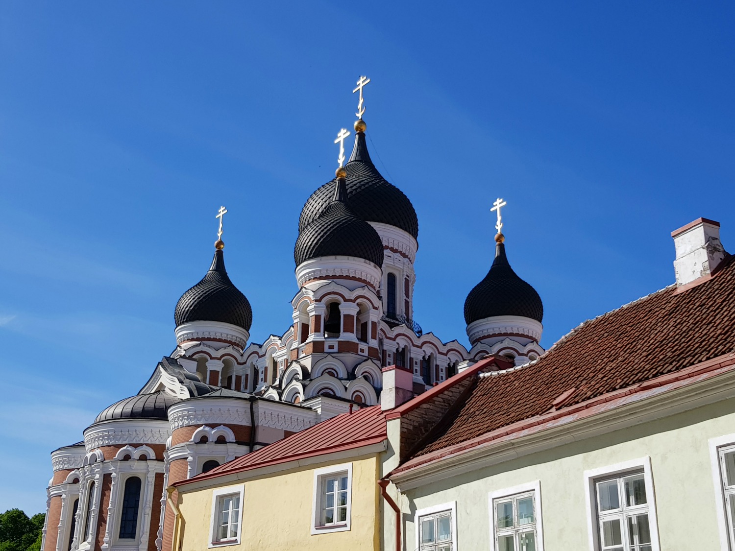 A view across buildings on Toompea Hill to the Alexander Nevsky cathedral - the city's famously fairytale architecture is just one of the many reasons to visit Tallinn, Estonia