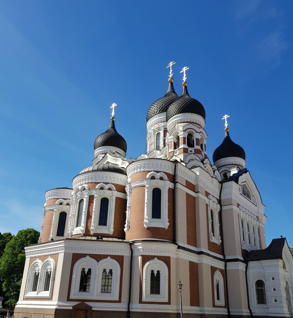 View of the white and red Alexander Nevsky Cathedral with its black domes - the city's famously fairytale architecture is just one of the many reasons to visit Tallinn, Estonia