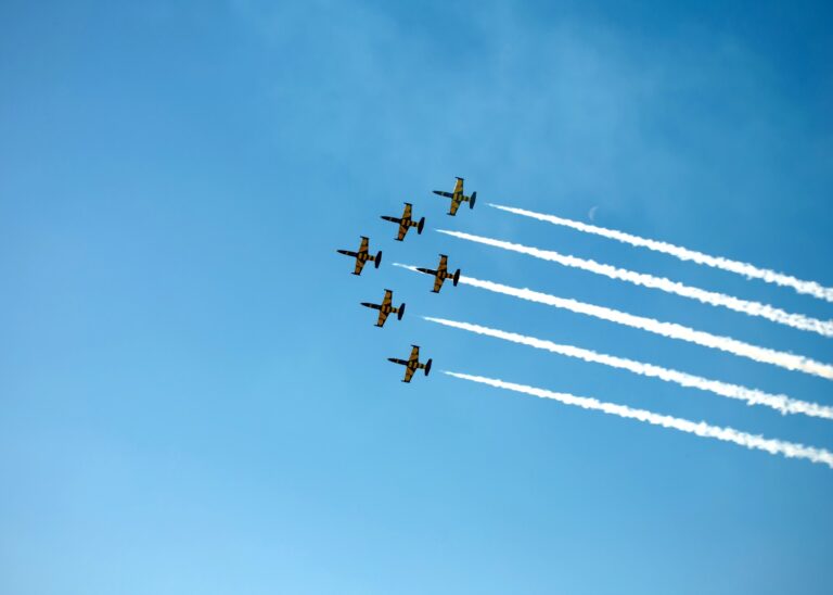 Six planes with white trails behind them fly in formation against a blue sky - remembering six years of travels with a child