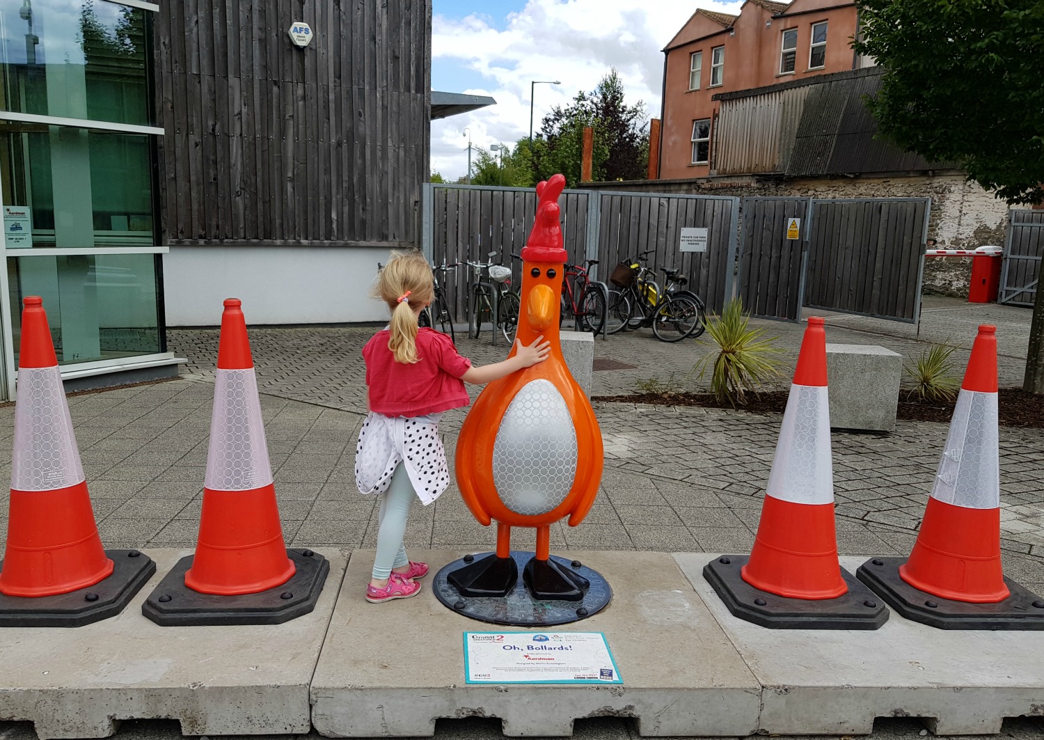 My daughter with Feathers McGraw disguised as a traffic cone in Oh Bollards - following the Gromit Unleashed 2 trail in Bristol, our review