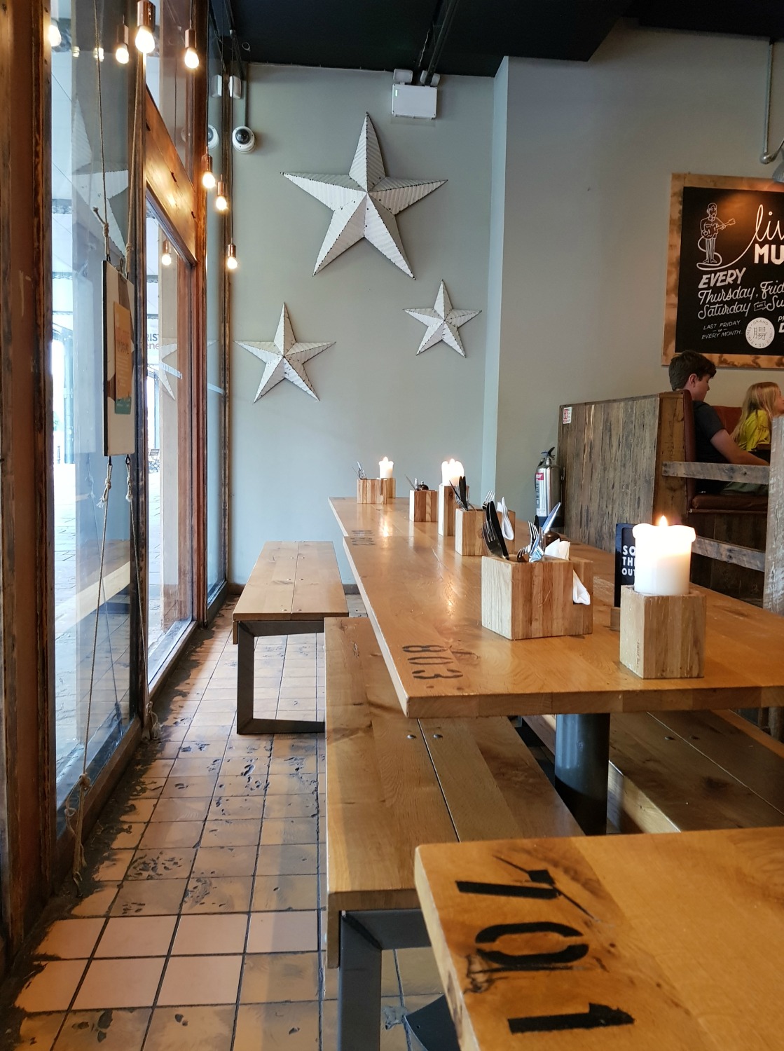 View of the tables and star decorations on the wall at The Stable - following the Gromit Unleashed 2 trail in Bristol, our review