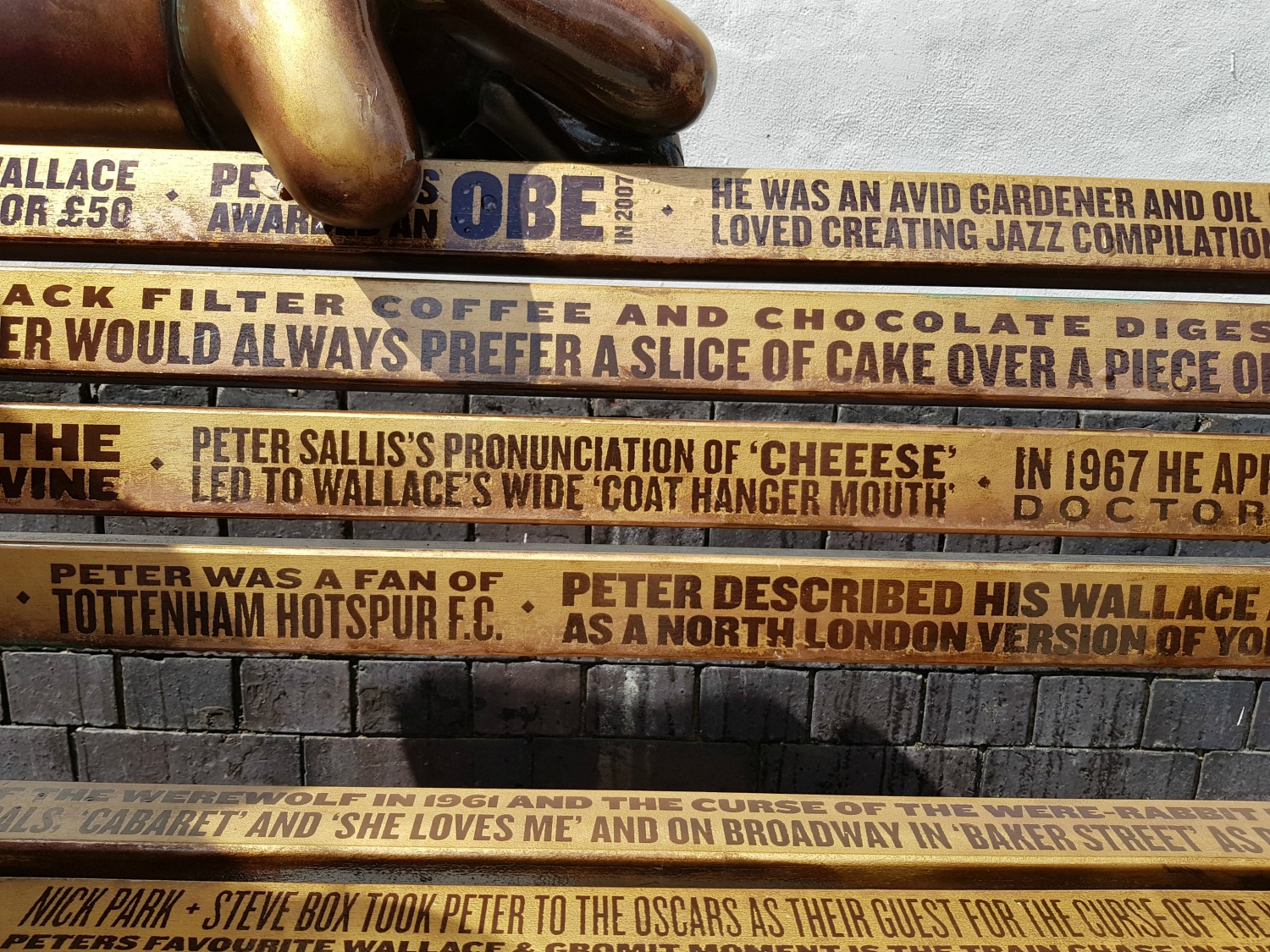 Close up of some of the trivia about actor Peter Sallis on the golden bench of A Grand Tribute - following the Gromit Unleashed 2 trail in Bristol, our review