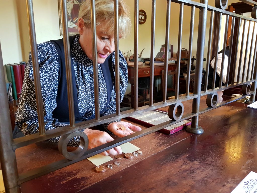 Bank staff counts out the special old money used at the Victorian Town open air museum - my Blists Hill review for the family-friendly attraction in Ironbridge Gorge, Shropshire