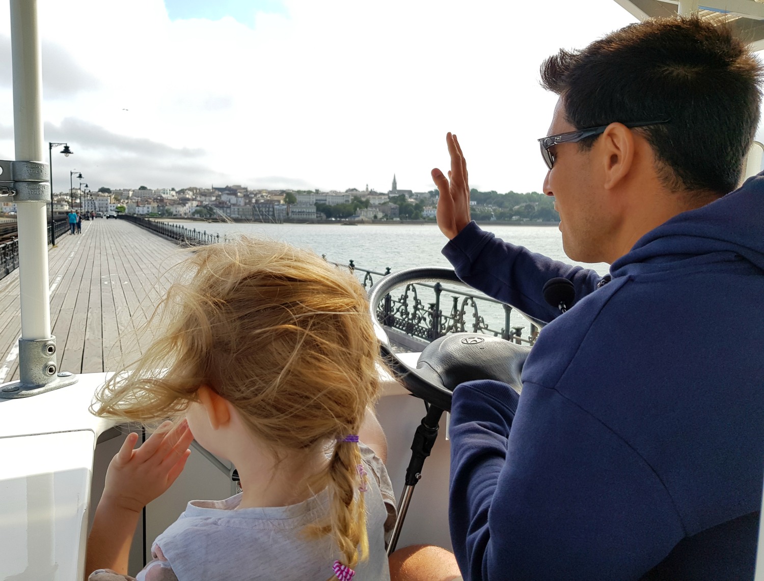My daughter and BoRo bike owner Dominic waving at people along our route from Ryde Pier back to Appley - an Isle of Wight bear hunt, exploring the island in the footsteps of the famous children's book