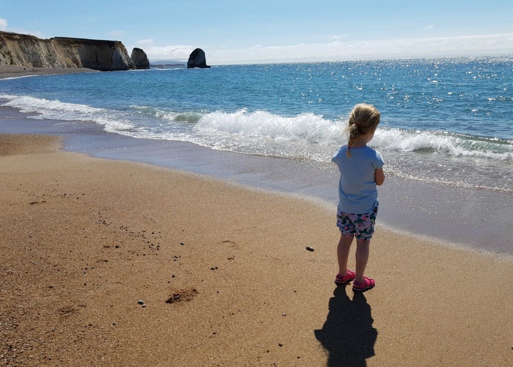 My daughter on the beach at Freshwater Bay - an Isle of Wight bear hunt, exploring the island in the footsteps of the famous children's book