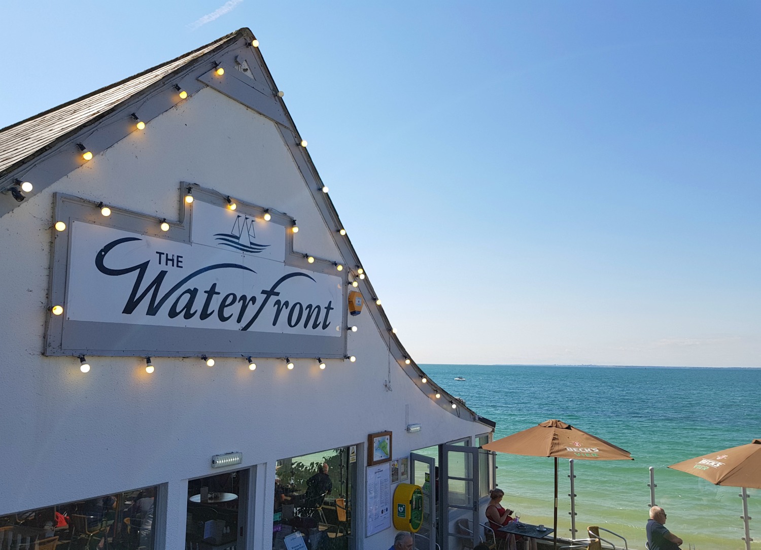A view of The Waterfront restaurant on Totland Bay with the sea in the distance - an Isle of Wight bear hunt, exploring the island in the footsteps of the famous children's book