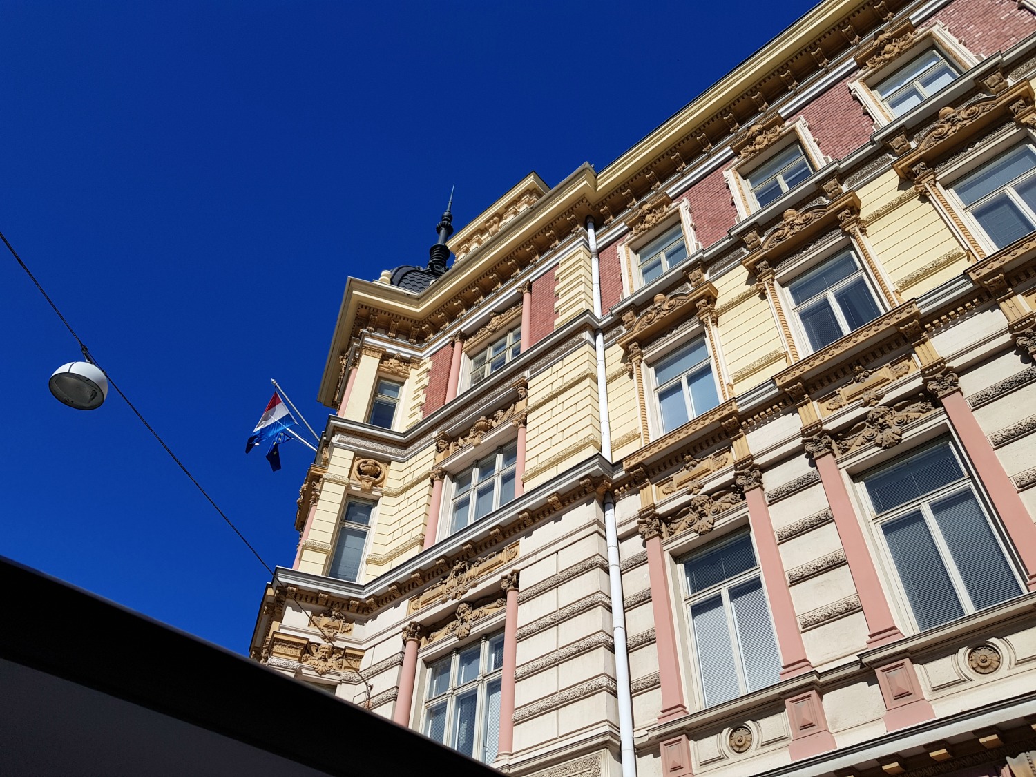 Elegant building with blue sky behind in Helsinki - the architecture is one of the top answers to the question why visit Helsinki?