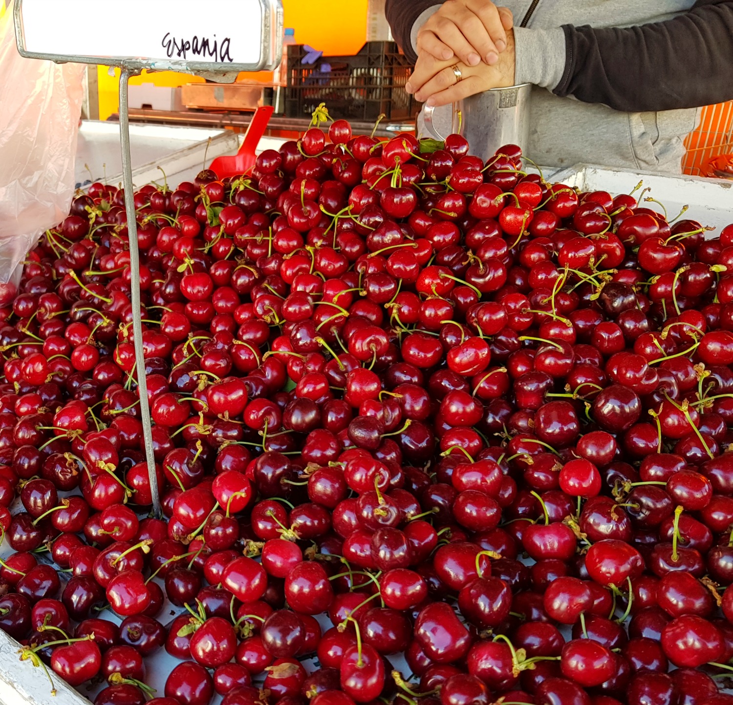 Piles of cherries at the market stall in Helsinki - the appreciation of the little things is one of the top answers to the question why visit Helsinki?