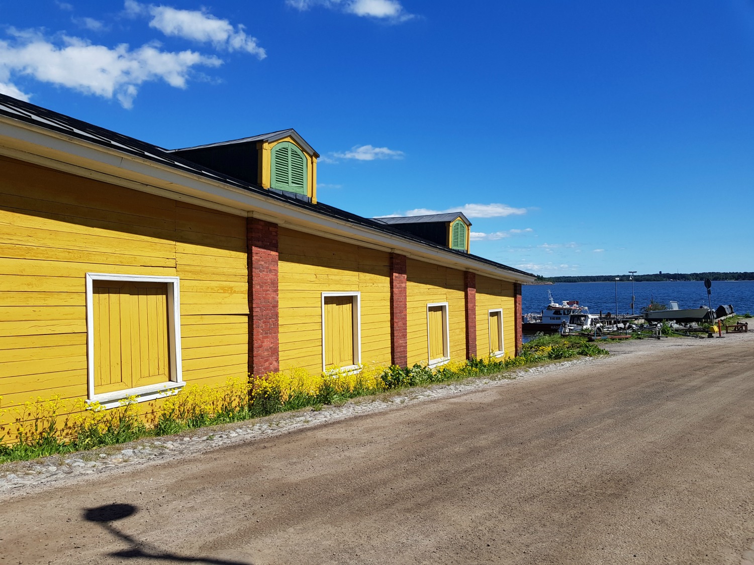Bright yellow buildings on the fortress island of Suomenlinna - the architecture and history is one of the top answers to the question why visit Helsinki?