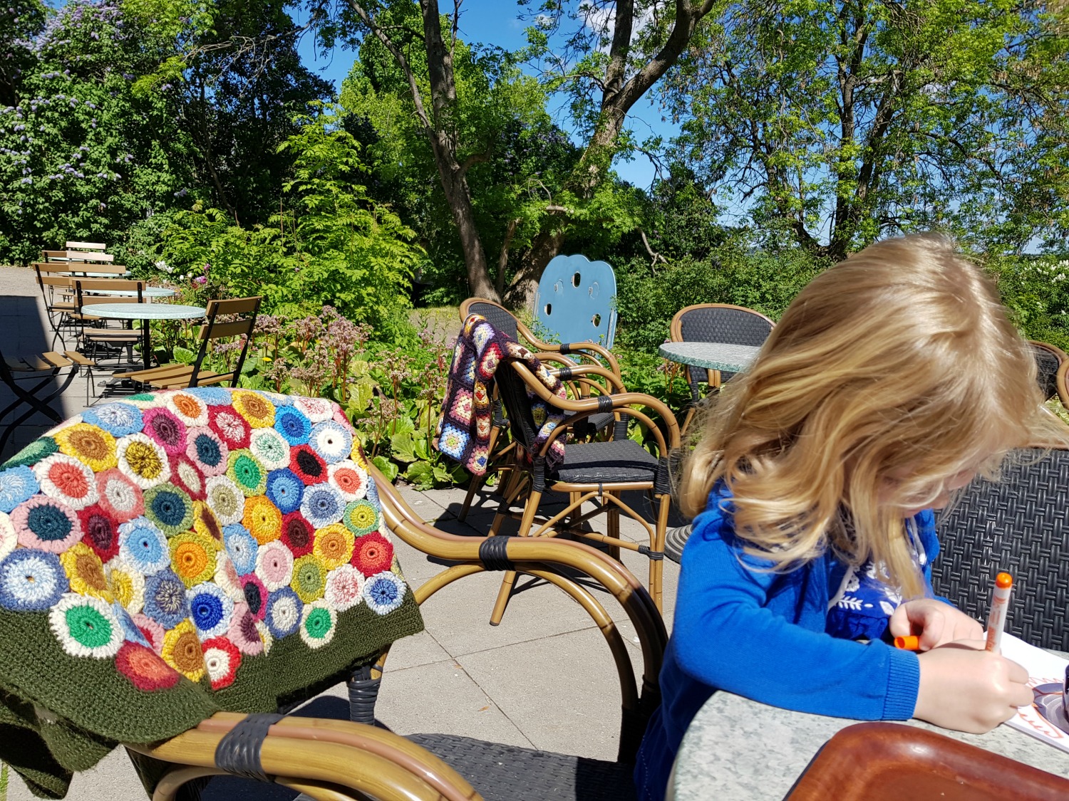 My daughter colouring in the cafe by Suomenlinna toy museum, one of the top things to do in Helsinki - my tips on visiting Suomenlinna with kids