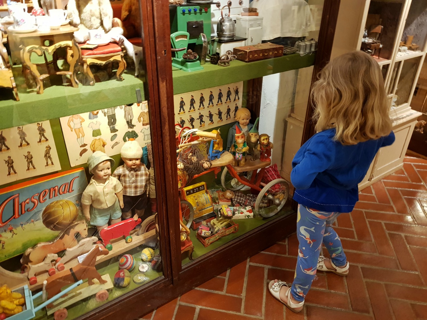 My daughter looks at a display in Suomenlinna toy museum in Helsinki - my tips on visiting Suomenlinna with kids