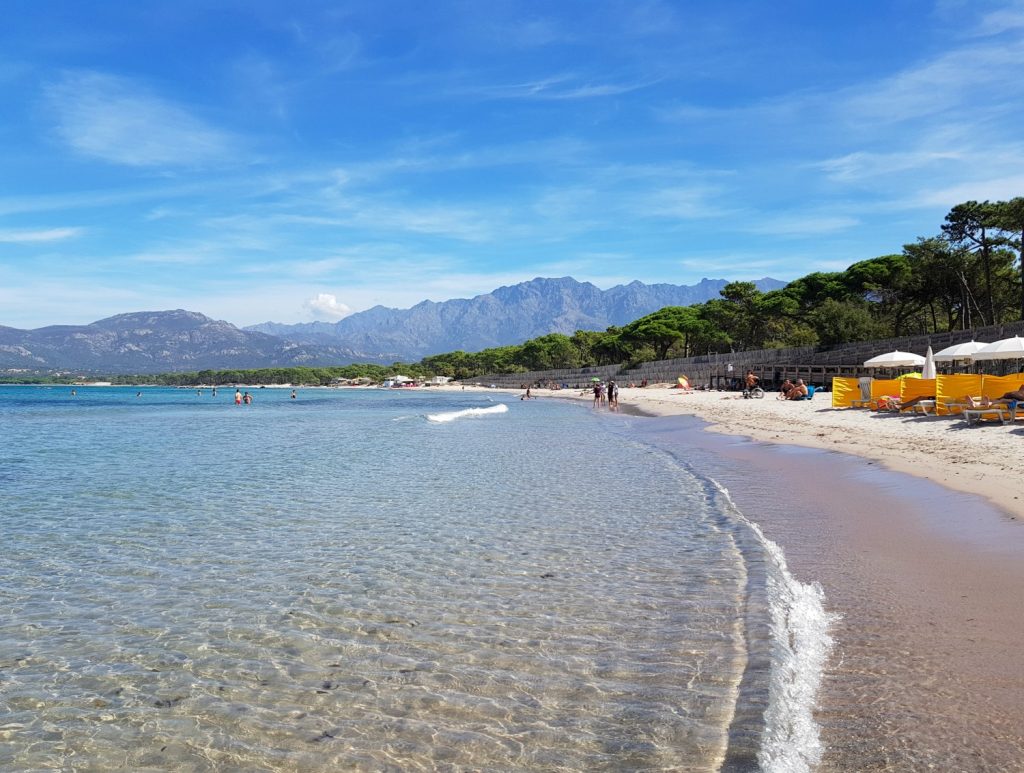 Mountains on the horizon behind the beach just outside Calvi in Corsica - looking back over my last month of travel