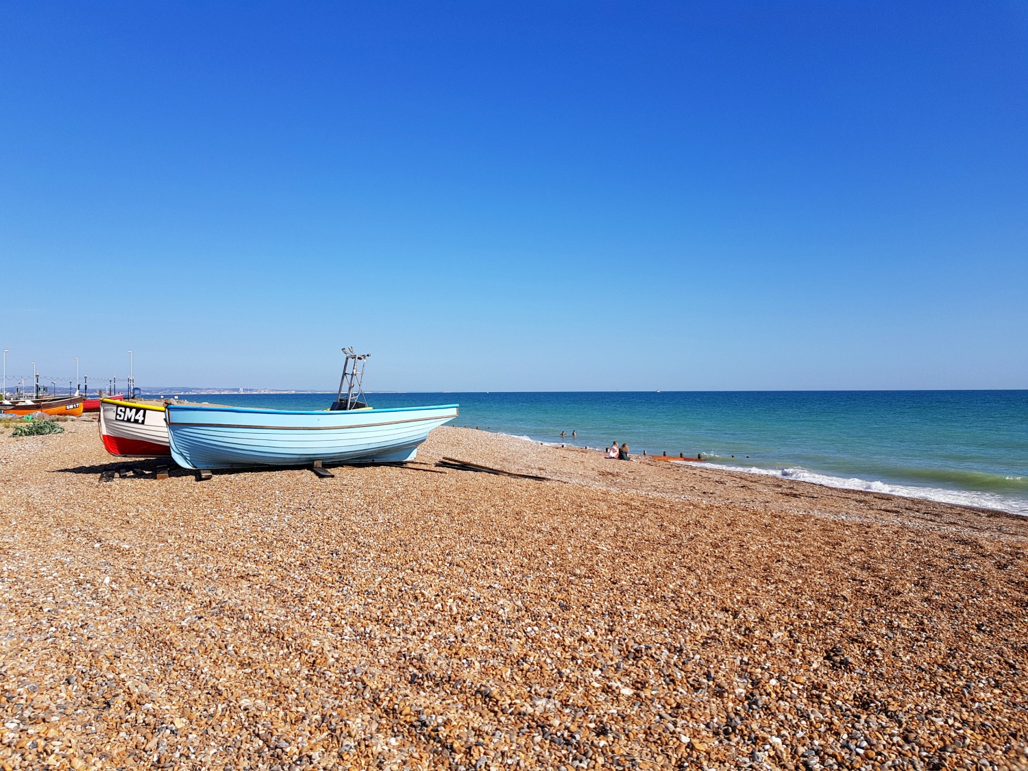 Colourful boats pulled up onto the shingle in Aldeburgh, Suffolk