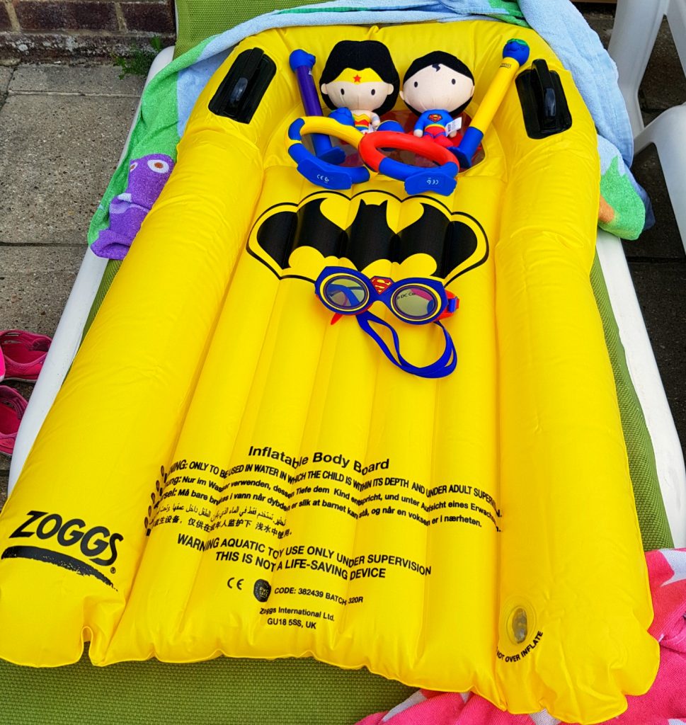 Selection of products from the Zoggs holiday shop, including Batman surf rider, Justice League soakers and seal diving sticks and rings - - helping kids' water confidence with Zoggs swimming aids