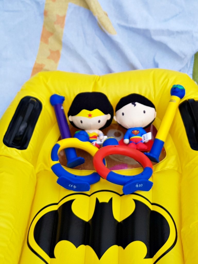 Close-up of some of the products from the Zoggs holiday shop, including Batman surf rider, Justice League soakers and seal diving sticks and rings - - helping kids' water confidence with Zoggs swimming aids
