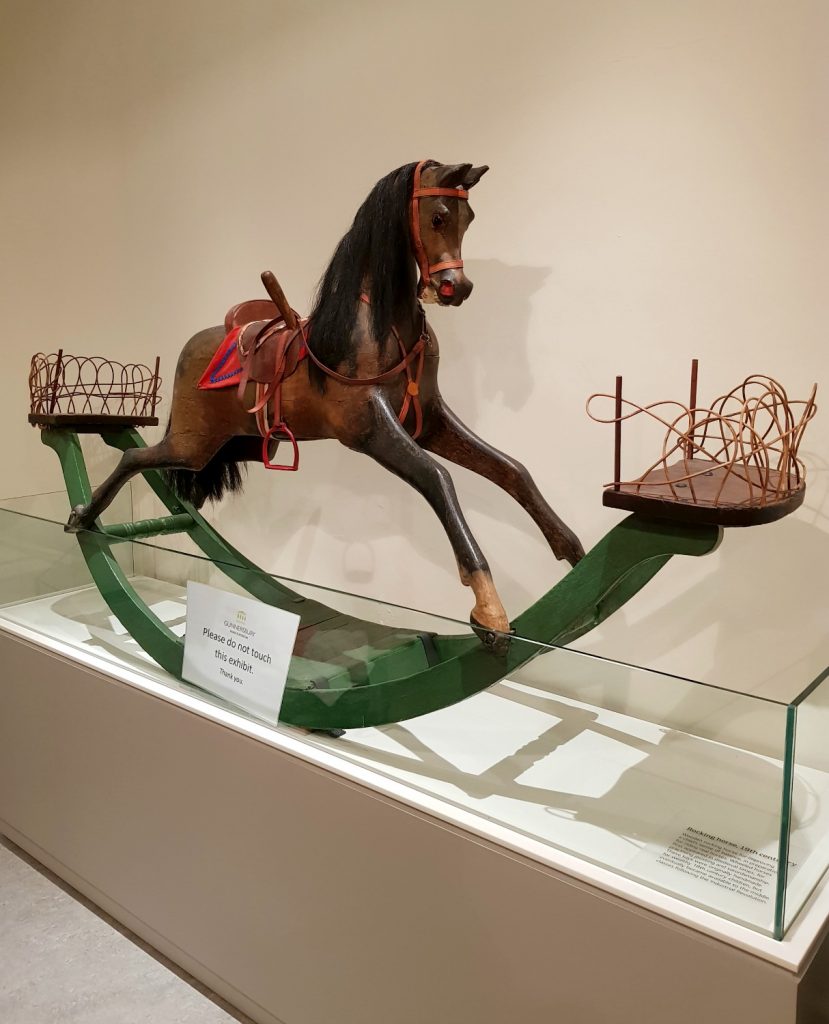 The eye-catching vintage rocking horse in one of the galleries with other traditional children's toys - my review of a free day out in London, visiting Gunnersbury Park Museum with kids