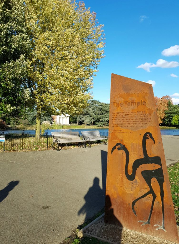 Sign with flamingos on in front of the lake and Doric temple - my review of a free day out in London, visiting Gunnersbury Park Museum with kids