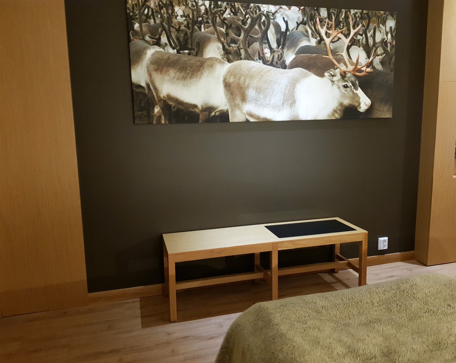 Fluffy throw at the end of the bed looking to a picture of reindee - my review of Hotel Levi Panorama, Lapland