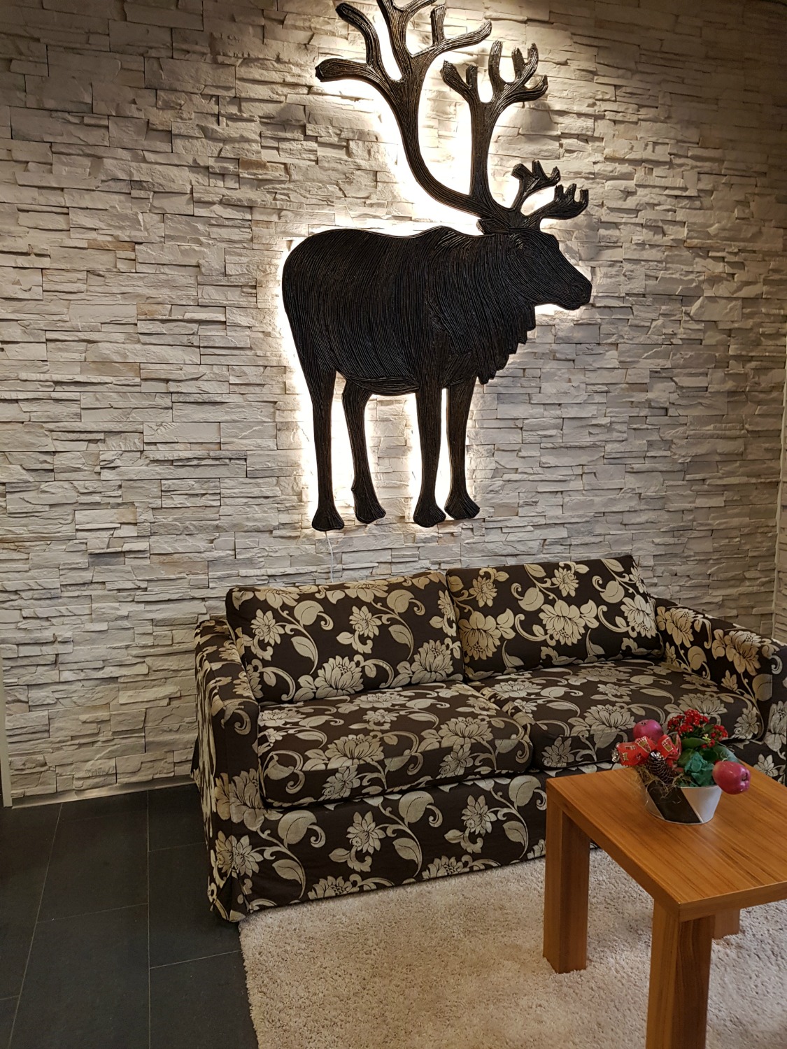 Illuminated moose behind a sofa in the lobby - my review of Hotel Levi Panorama, Lapland