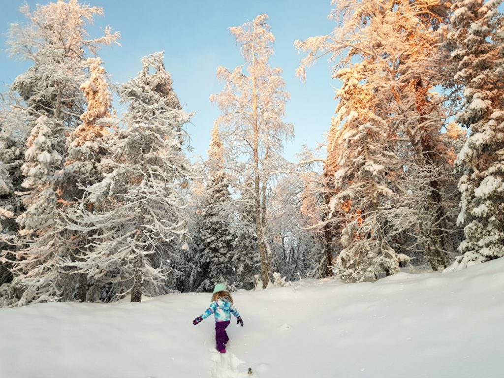 My daughter exploring the snow and heading into the snowy trees by Levi Panorama hotel - my review of Hotel Levi Panorama, Lapland