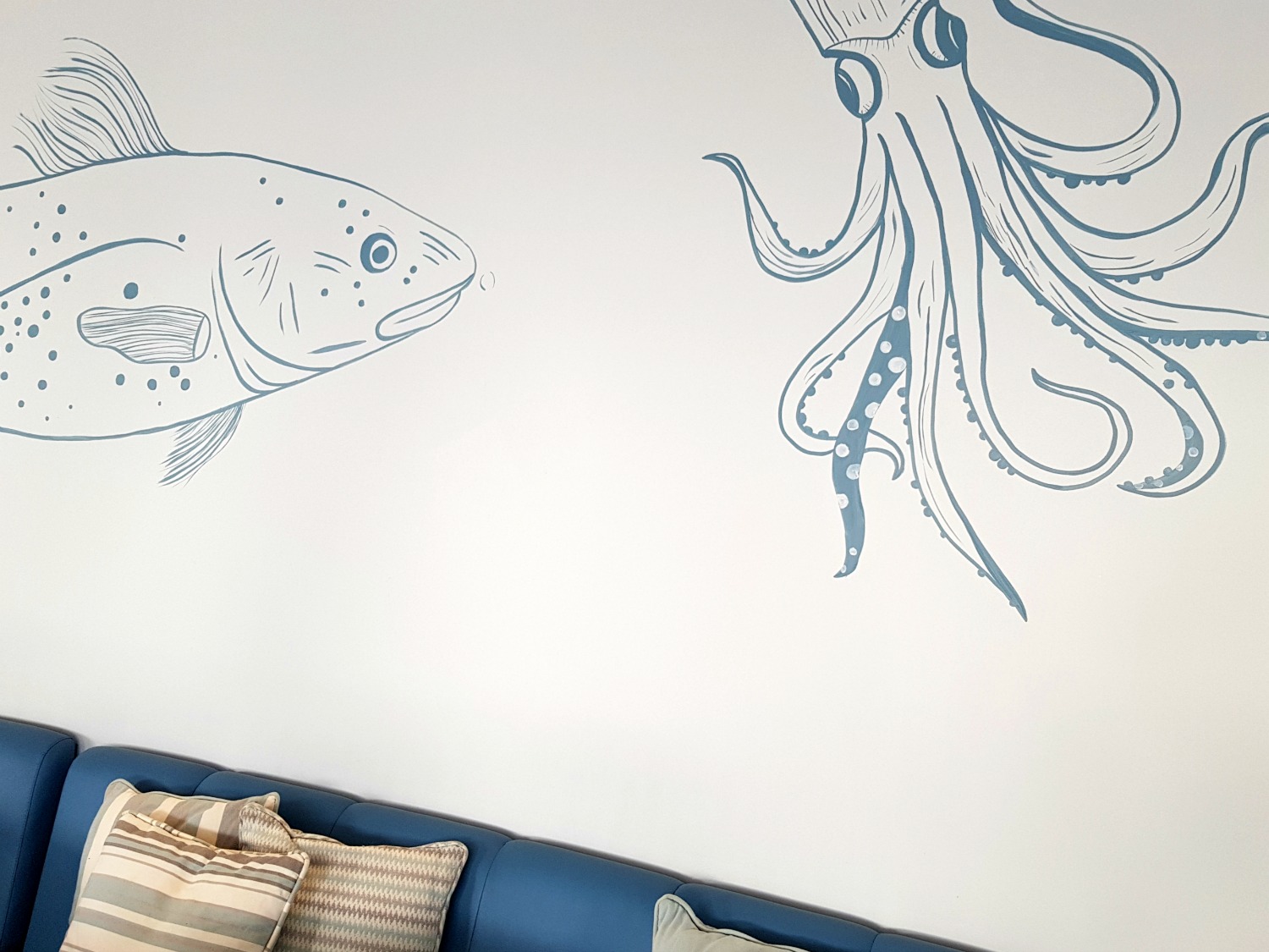 Blue octopus decor against a white background in Ouzo restaurant at Ikos Dassia - my review of Ikos Dassia with kids, a family holiday in Corfu