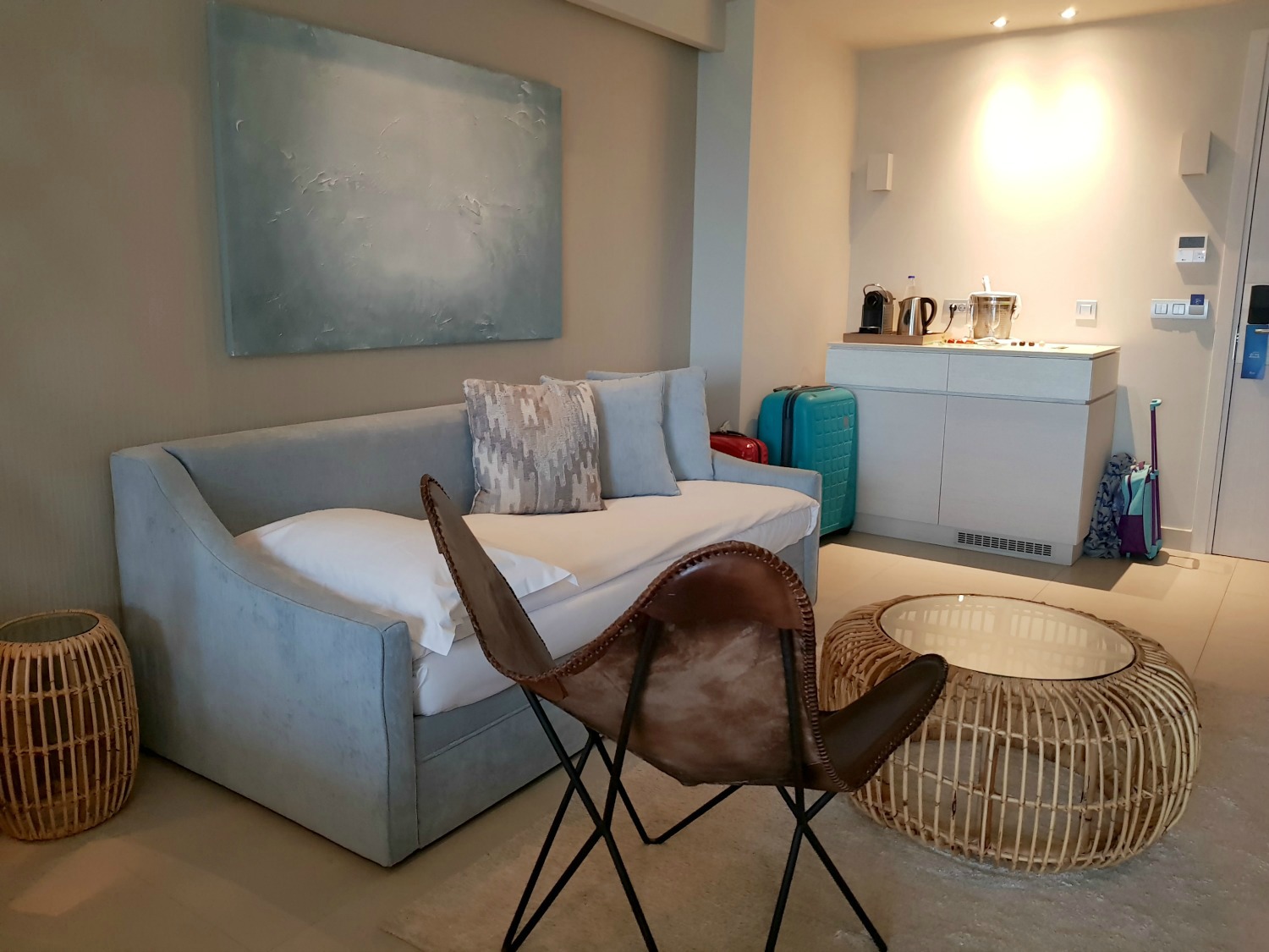 Chair and sofa which converts to bed plus kitchenette with nespresso machine, kettle and fridge in the background - my review of Ikos Dassia with kids, a family holiday in Corfu