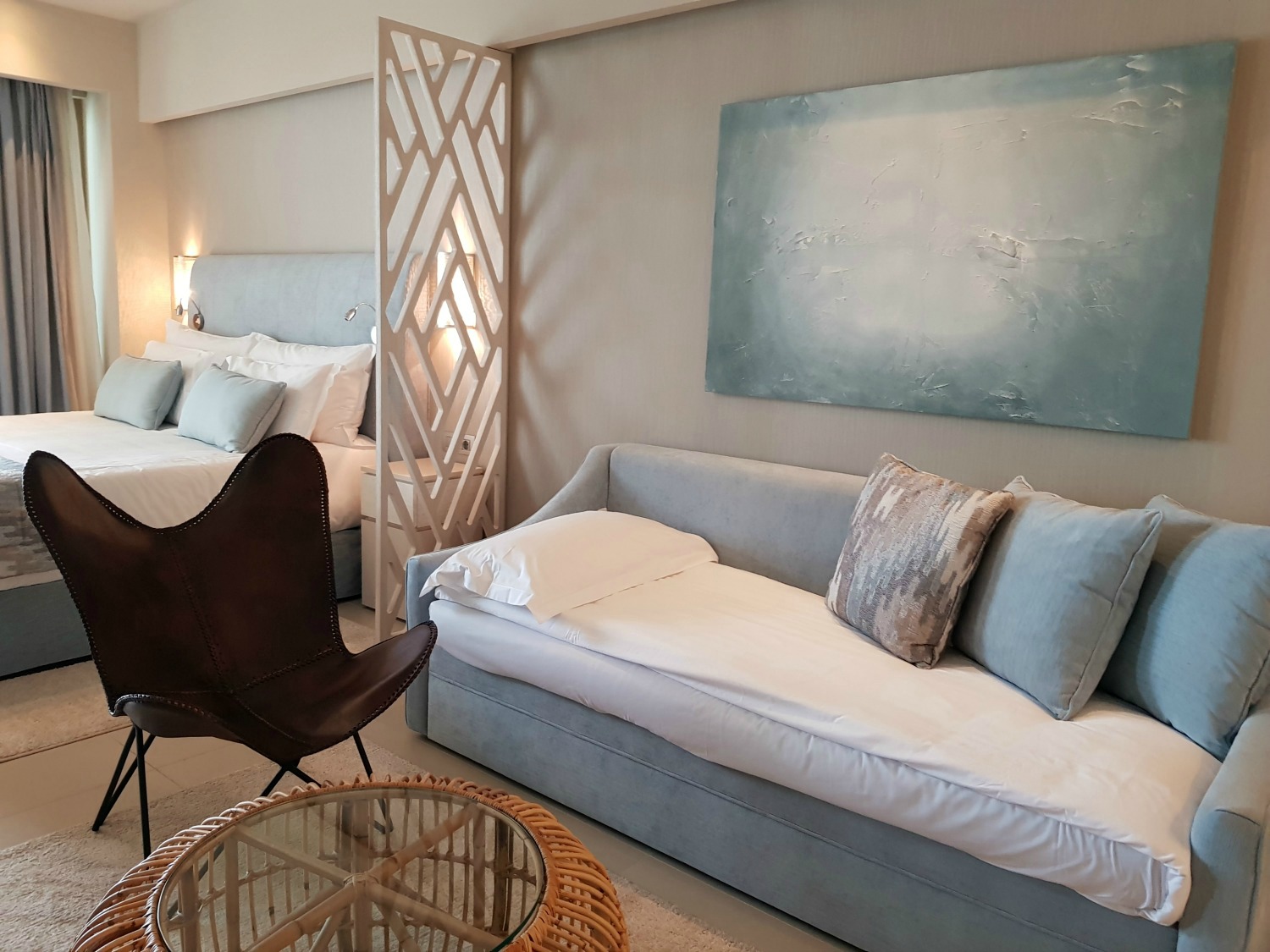View across the sofa, made up as a bed, towards the main bed in our junior suite at Ikos Dassia - my review of Ikos Dassia with kids, a family holiday in Corfu