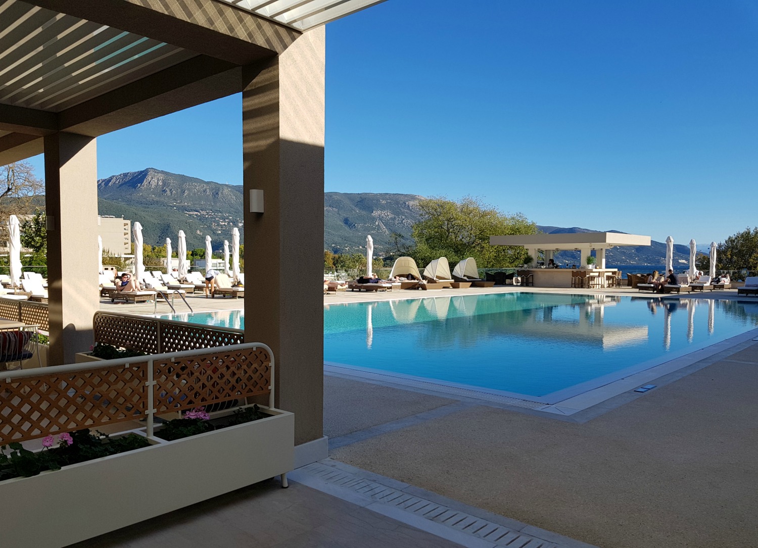 The adults only pool and part of Ergon Deli's tables at Sea at Ikos Dassia - my review of Ikos Dassia with kids, a family holiday in Corfu
