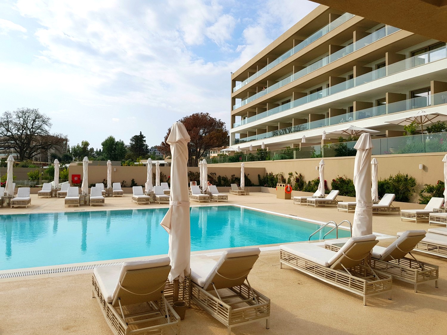 The adults only pool and Sky building behind at Ikos Dassia - my review of Ikos Dassia with kids, a family holiday in Corfu