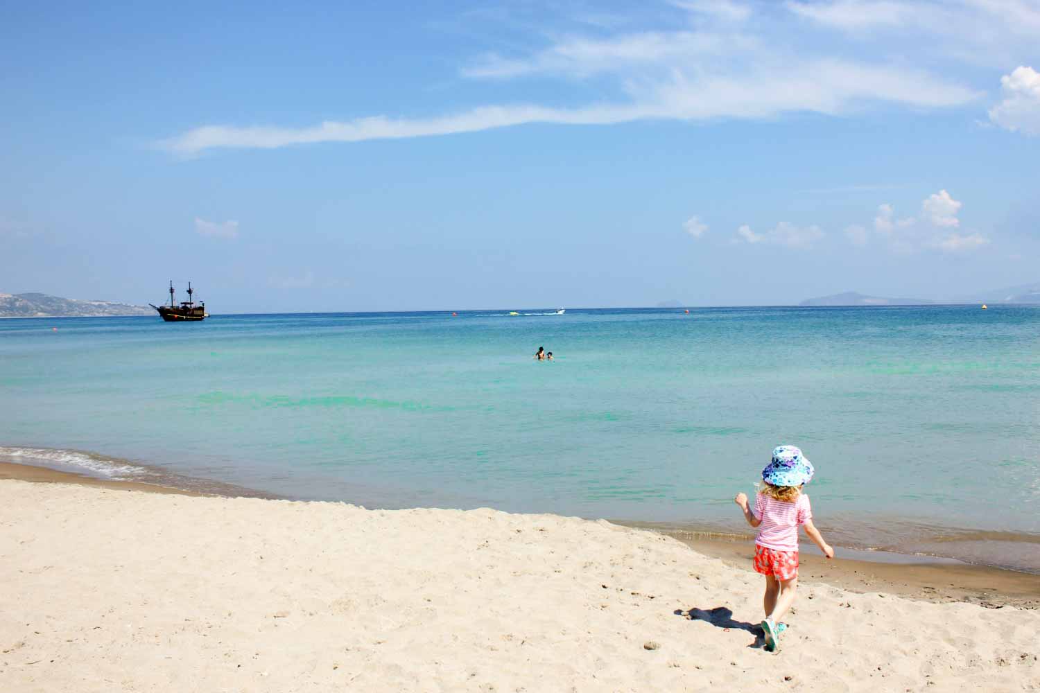 My daughter runs towards the sea on the Greek island of Kos - finding the perfect beach for families in Europe