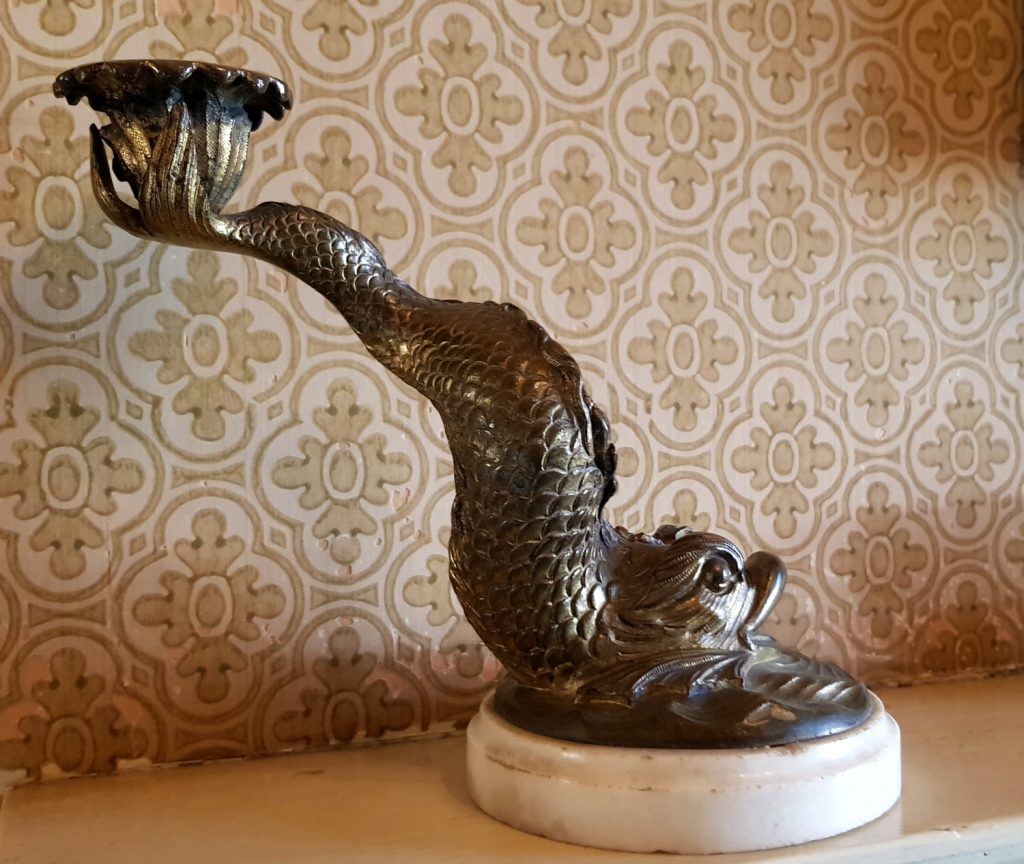 A candlestick holder designed like a fish in the 19th century house at Scotney Castle, in Kent - our winter day out at Scotney Castle with kids