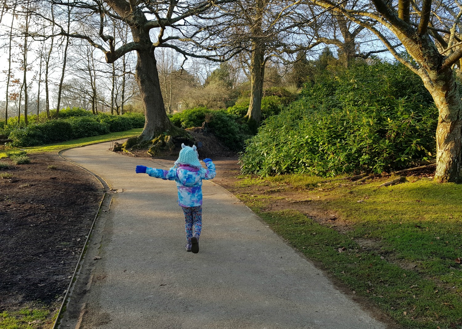 My daughter walking along the paths through the grounds at Scotney Castle - our winter day out at Scotney Castle with kids