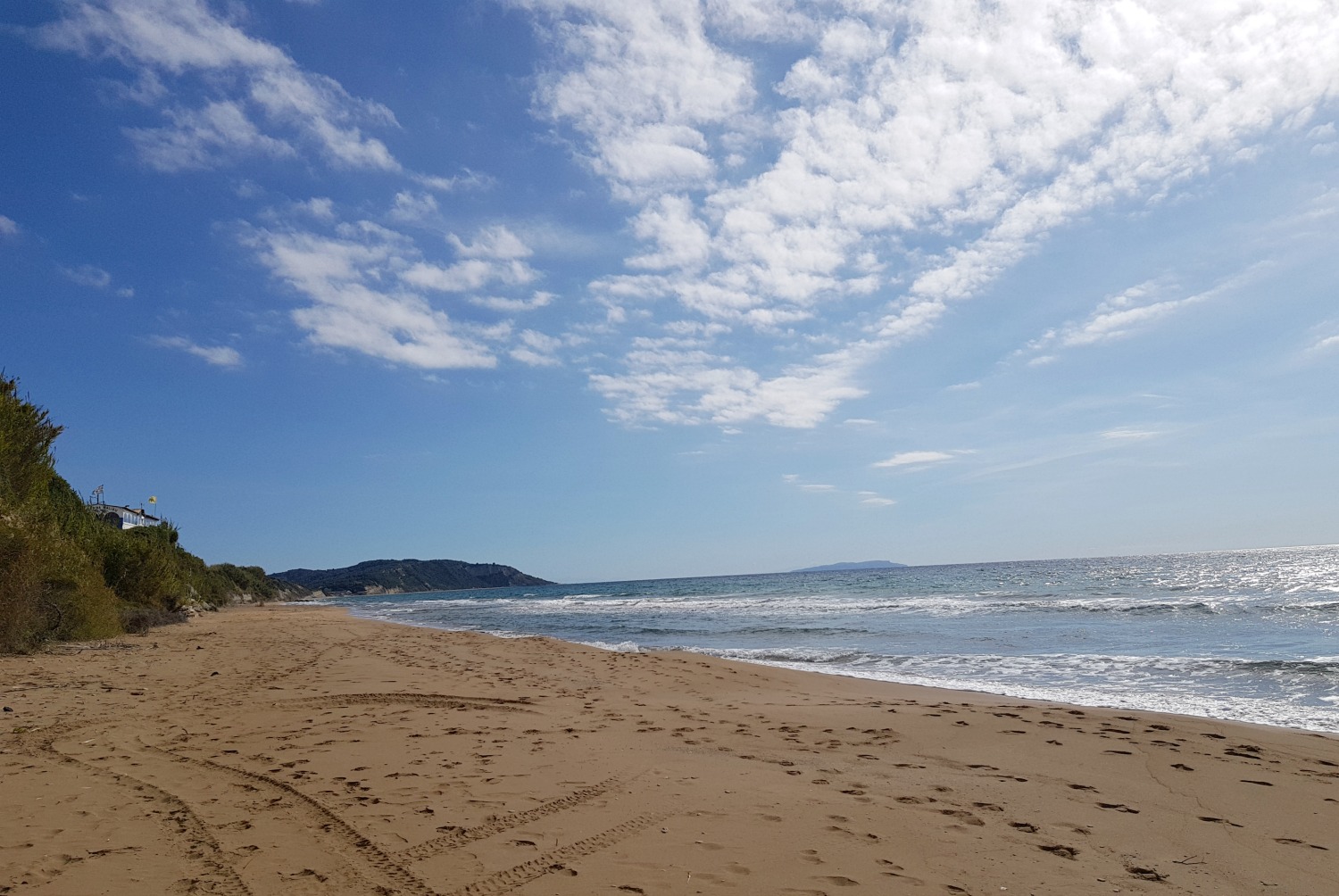 View across the beach to the cliffs near Agios Georgios South - one day in Corfu exploring some of the island in an Ikos Dassia mini