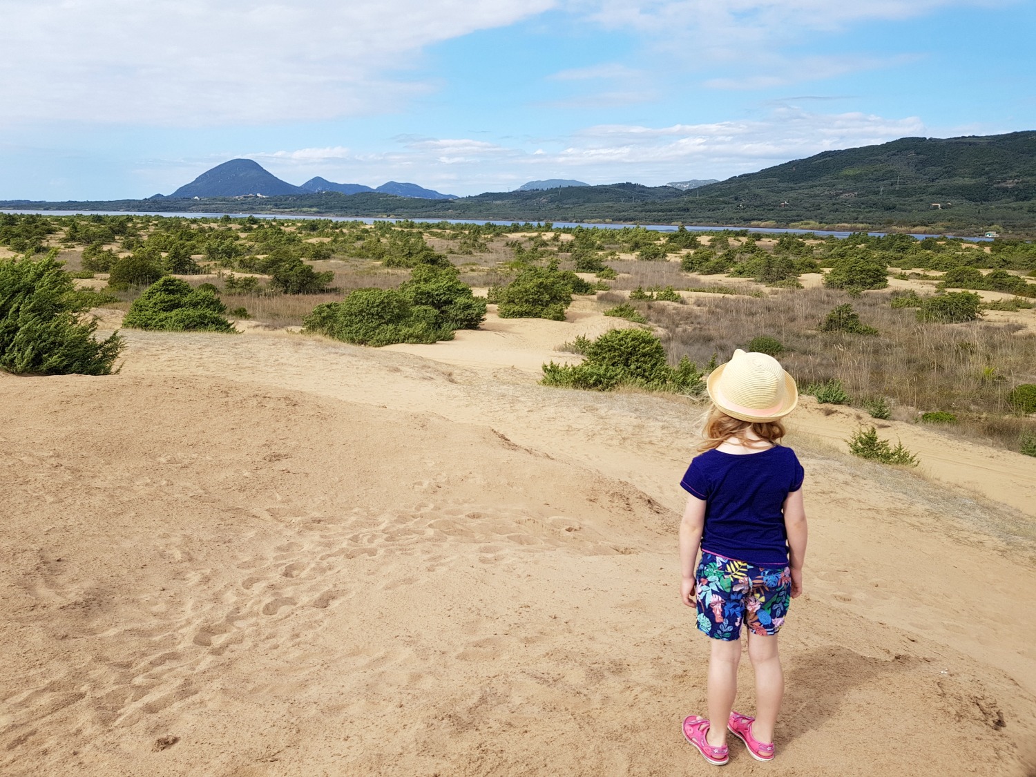 My daughter looks from the dunes out to Lake Korission at Issos beach - one day in Corfu exploring some of the island in an Ikos Dassia mini