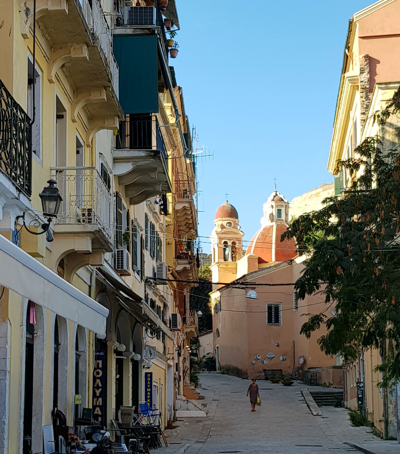 View towards a pastel painted church in Corfu Town - three things to do in Corfu Town with kids
