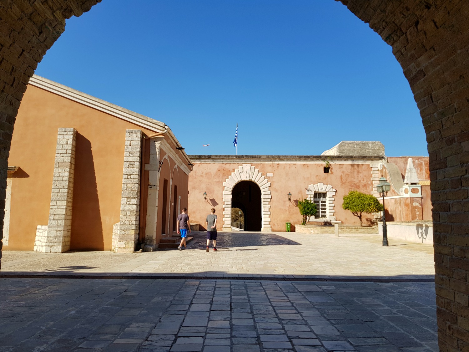 View through an archway into Corfu Town's old Venetian fortress - three things to do in Corfu Town with kids