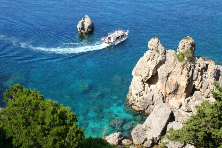 View down to the sea in Corfu across green Mediterranean cliffs - one day in Corfu exploring some of the island in an Ikos Dassia mini