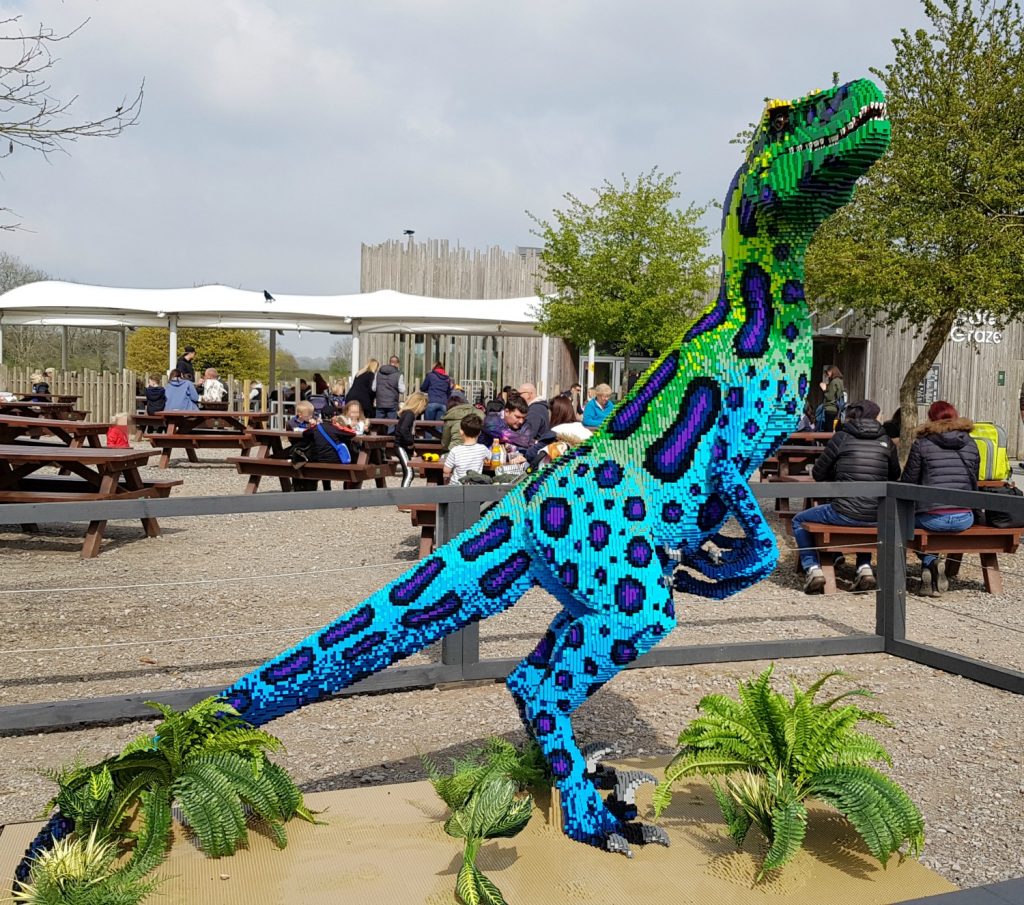 One of a pair of bright blue velociraptors among the Marwell Zoo Brickosaurs