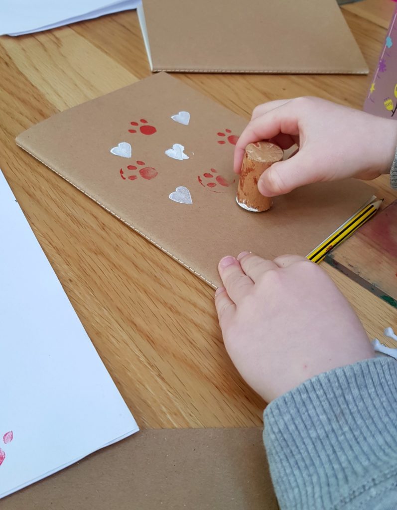 My daughter prints her notebook at the craft activity workshop at Penhein