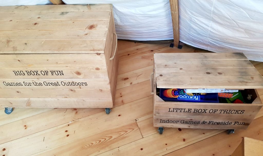 Boxes of indoor and outdoor toys in the communal tent - my Penhein glamping review