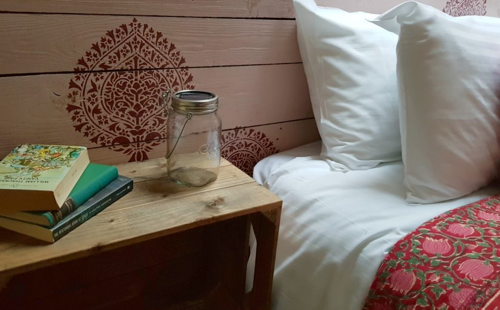 Close-up of the pillow and bedside table in the tent at Penhein glamping