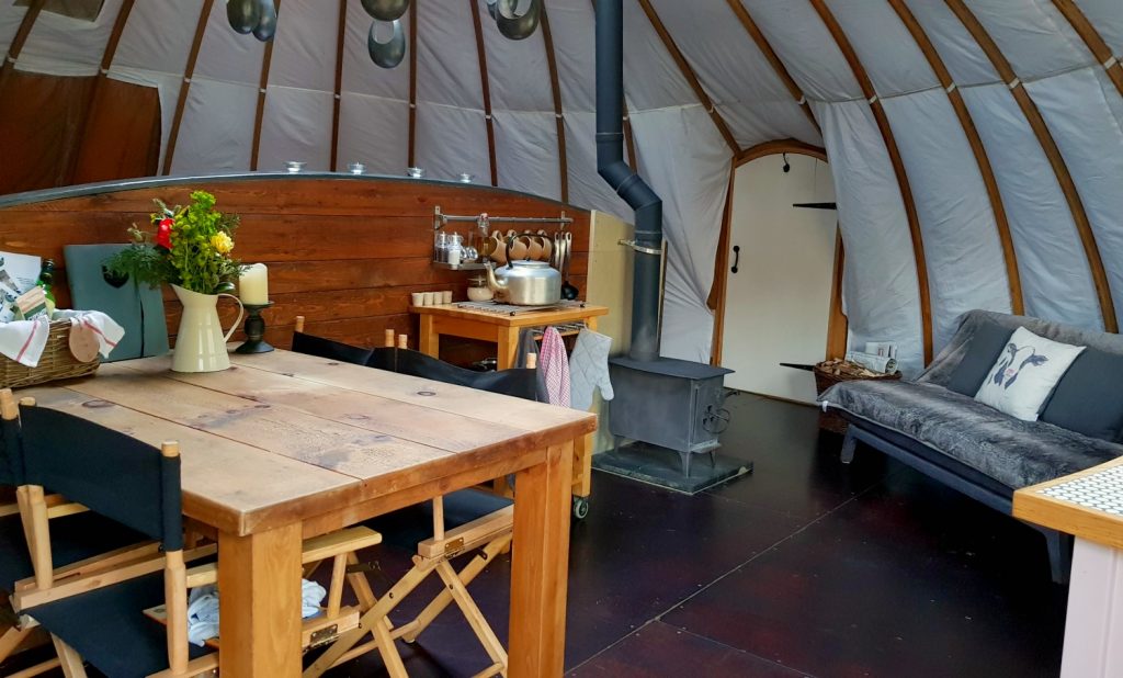Dining table and view across to the woodburning stove in our tent at Penhein glamping