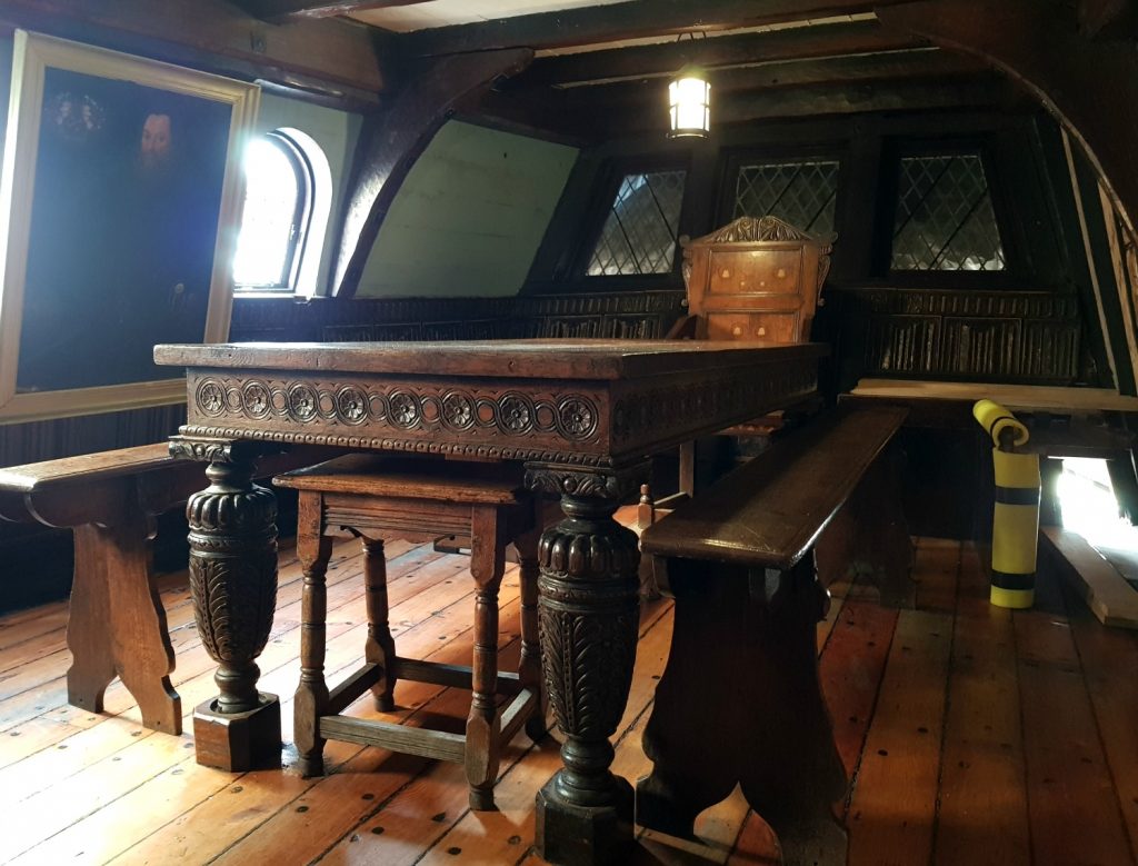 Heavy oak furniture in the master's cabin on the Golden Hinde