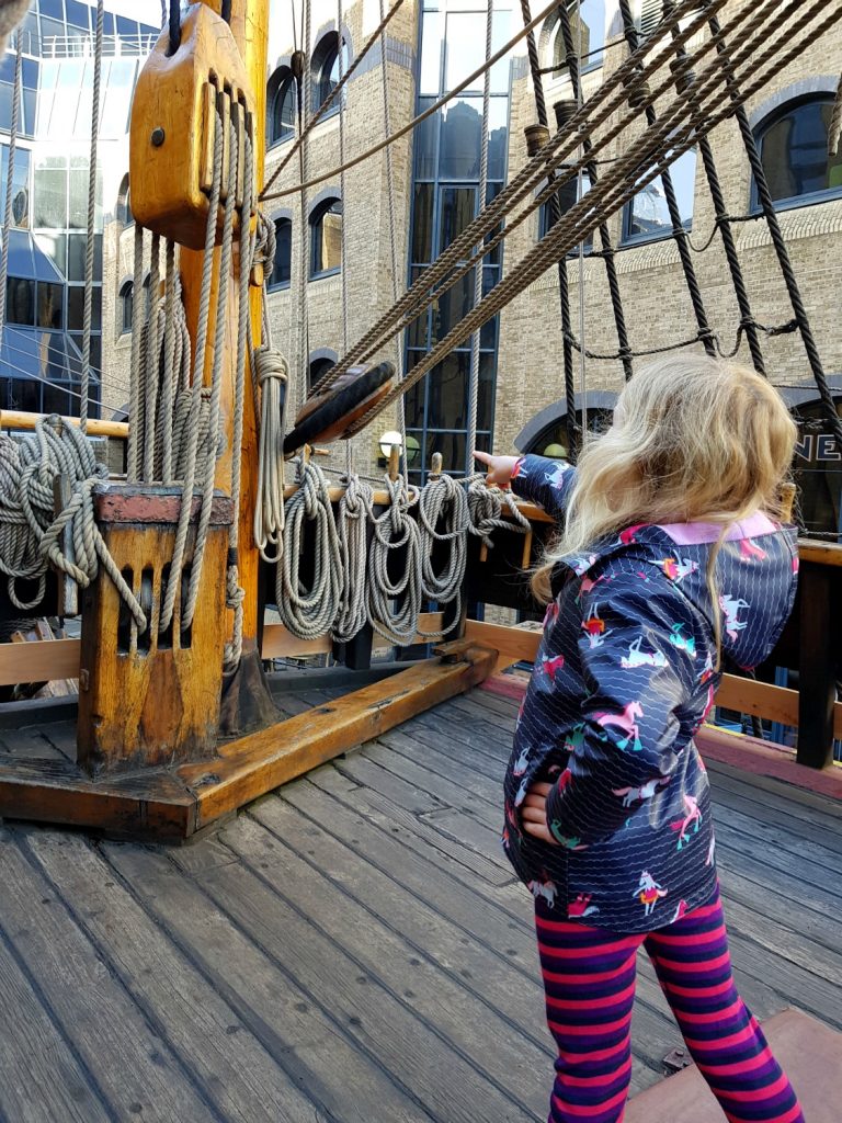My daughter looks out for pirates from the poop deck of the Golden Hinde