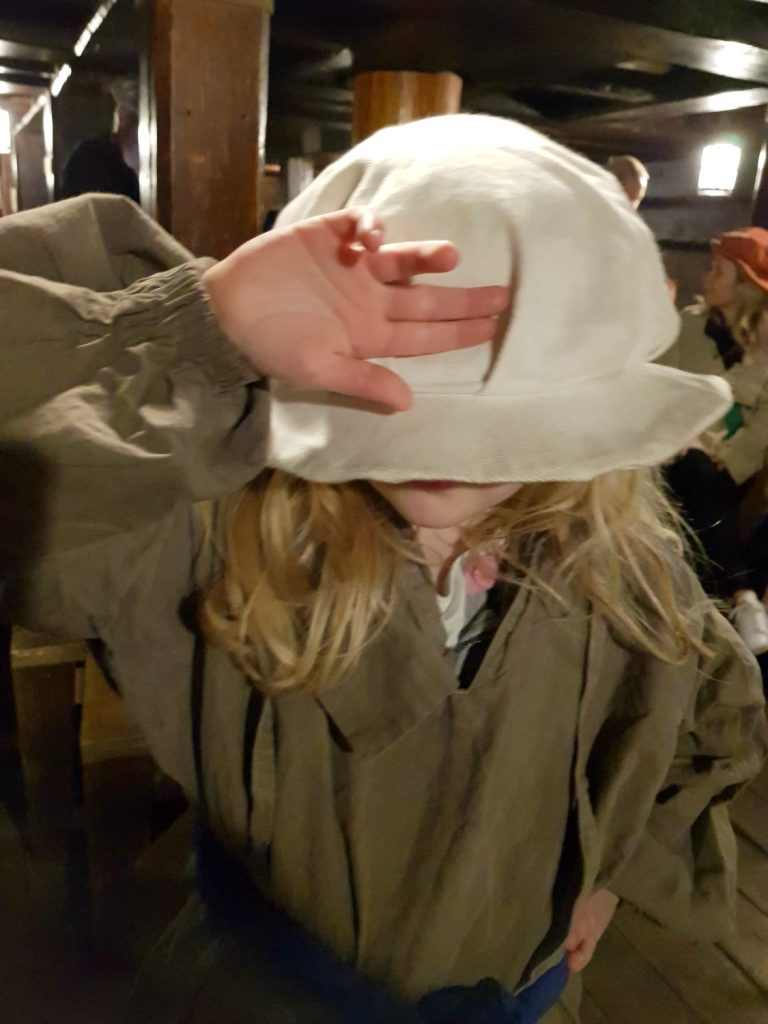 My daughter dressed up in a Tudor sailor's clothes including huge floppy hat on our Golden Hinde sleepover experience