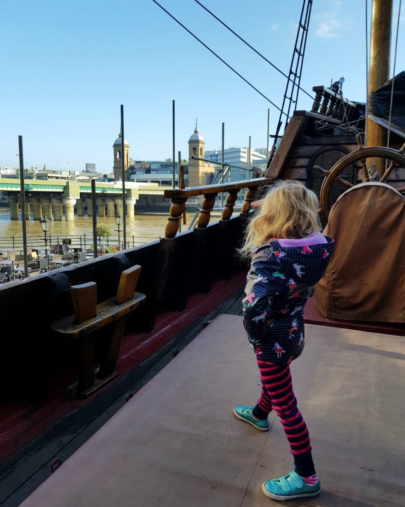 My daughter looks out to the river from the upper deck of the Golden Hinde