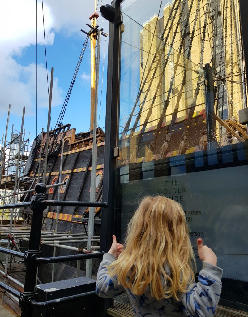 My daughter by the entrance to the Golden Hinde with her thumbs up
