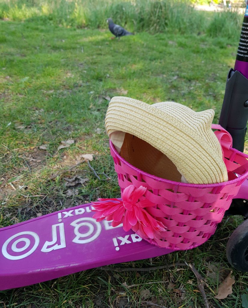 My daughter's Maxi Micro Scooter with basket on the footplate, containing a summer hat