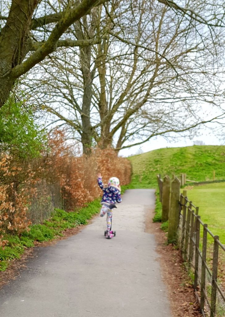 My daughter balancing with one leg in the air on her scooter - is a two wheel scooter or a three wheel scooter better for kids?